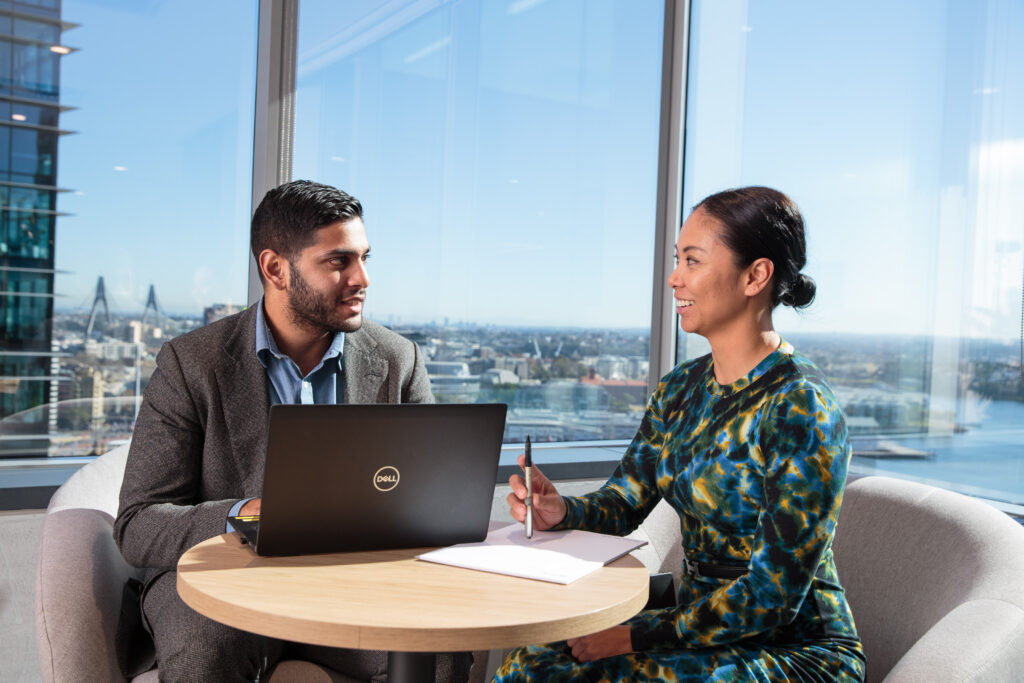 home page image, advisors chatting in front of window